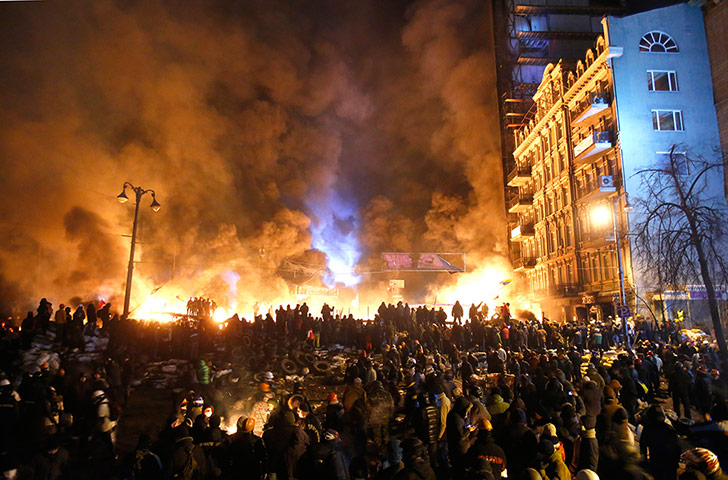 Black smoke rises during the clashes between protesters and police in Kiev